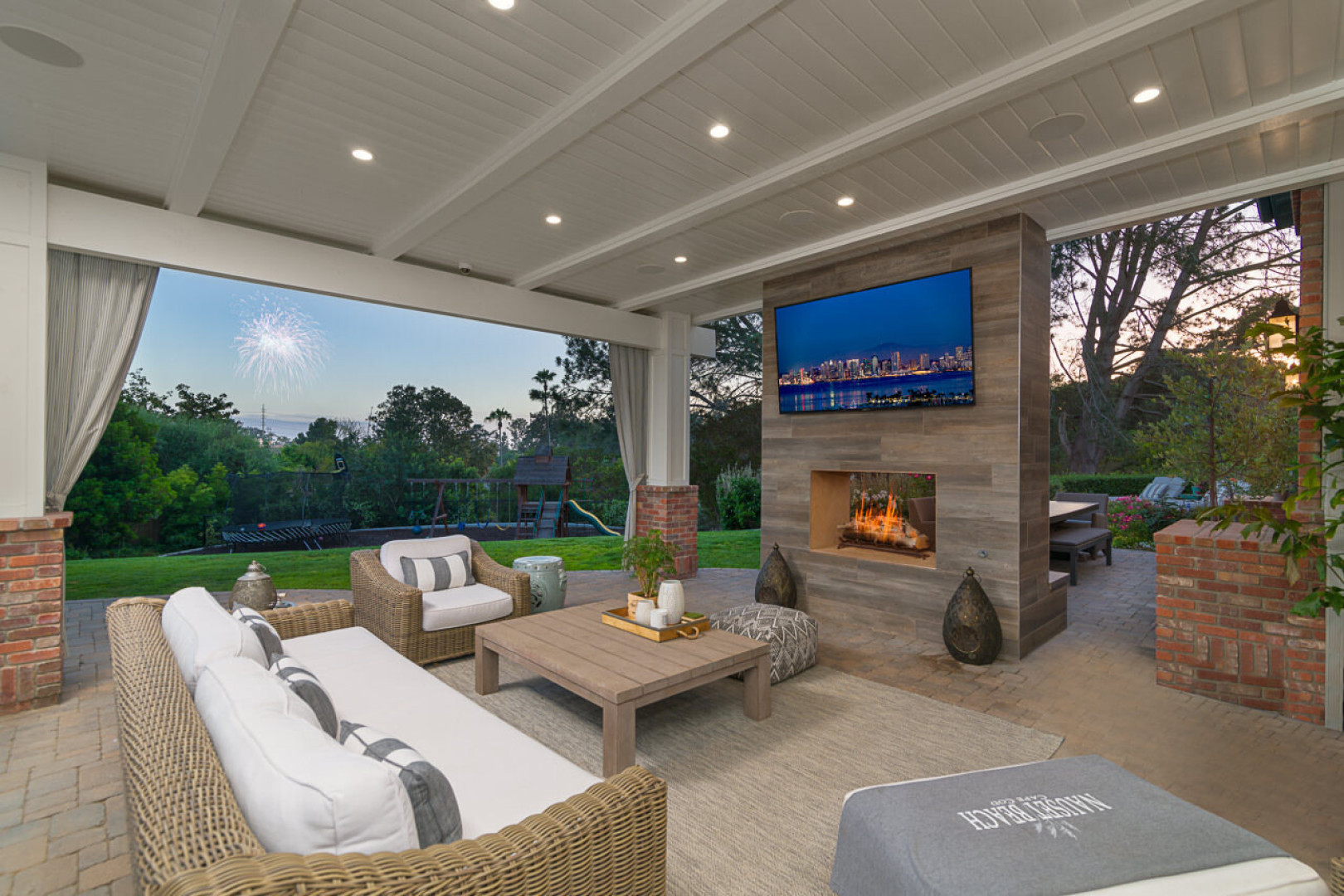 Custom outdoor living space boasting a fireplace and TV, Rancho Santa Fe CA