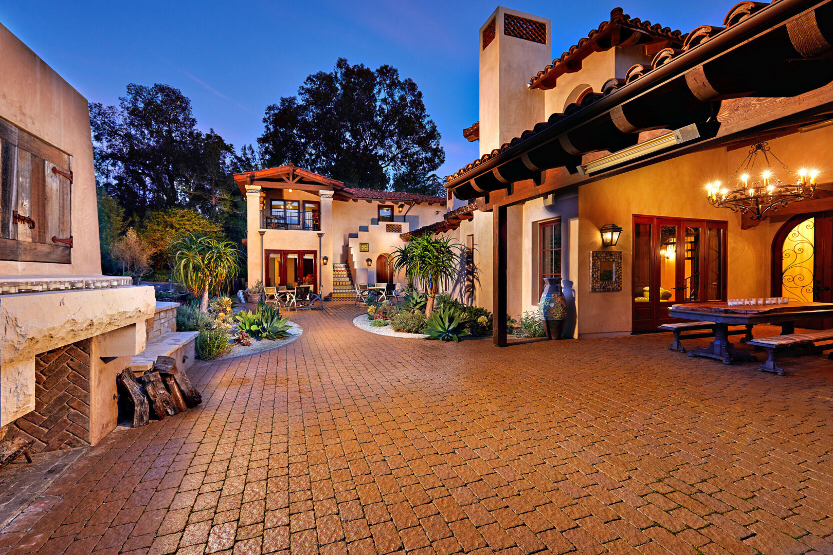 Exterior of tuscan inspired luxury home boasting a large outdoor living space, Rancho Santa Fe CA