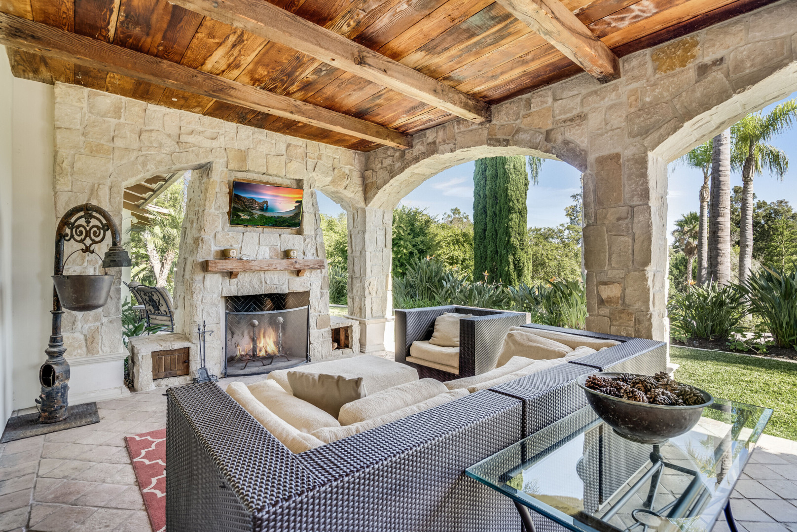 Luxury home boasting a beautiful outdoor living space made of wood and stone, Rancho Santa Fe CA