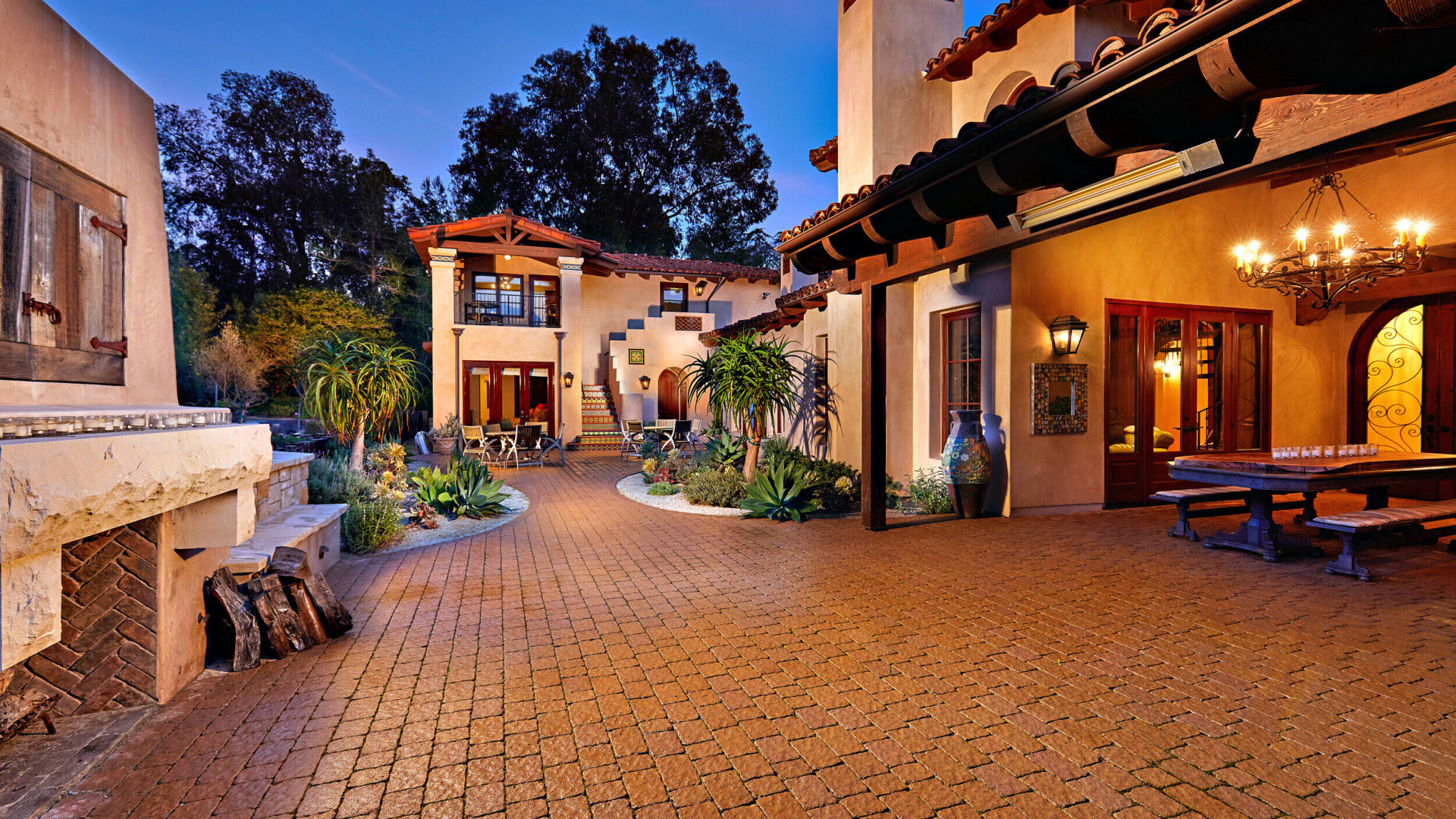 Exterior of tuscan inspired luxury home boasting a large outdoor living space, Rancho Santa Fe CA