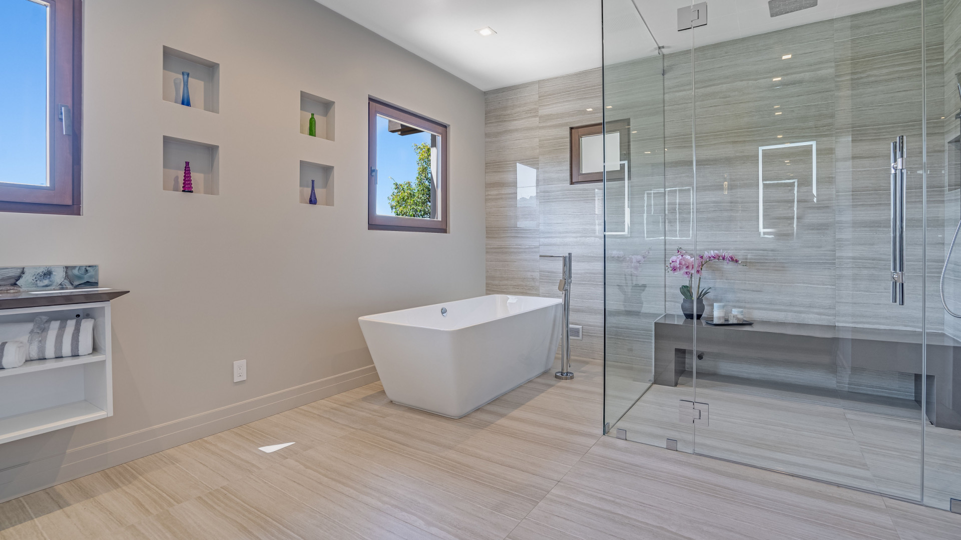 Modern primary bathroom boasting a large walk-in shower with a built-in seat, Rancho Santa Fe CA